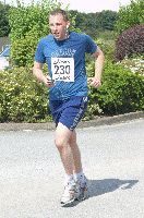 Andy Kingston drags his weary feet to the line